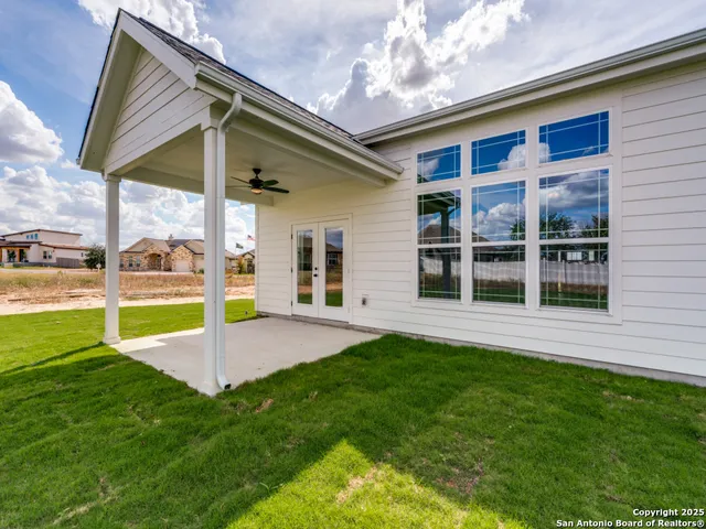 a view of an house with backyard and porch