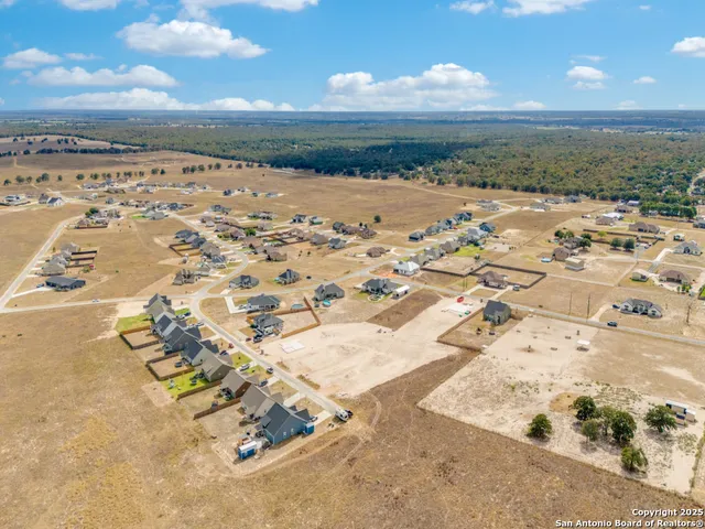 an aerial view of a house with a swimming pool