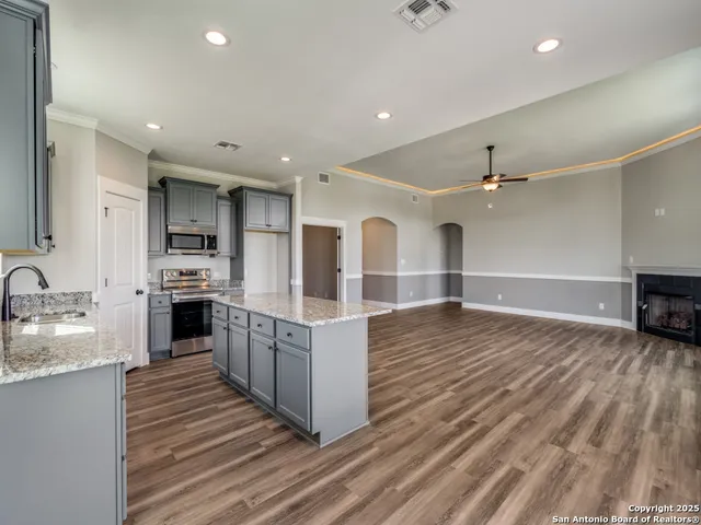 a large kitchen with stainless steel appliances kitchen island granite countertop a large counter top and sink