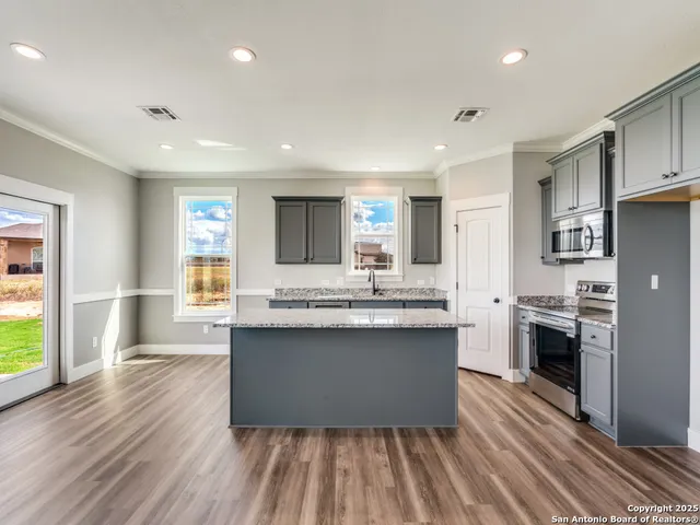 a kitchen with stainless steel appliances a sink stove and refrigerator