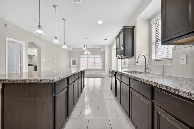 a kitchen with granite countertop counter space a sink stainless steel appliances and cabinets
