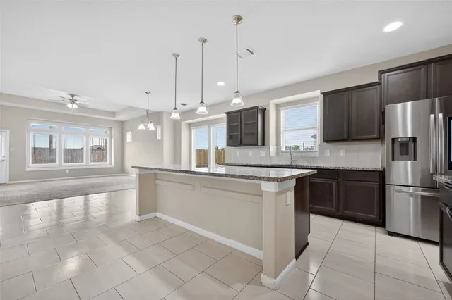 a kitchen with stainless steel appliances granite countertop a stove top oven a sink a counter top space and cabinets