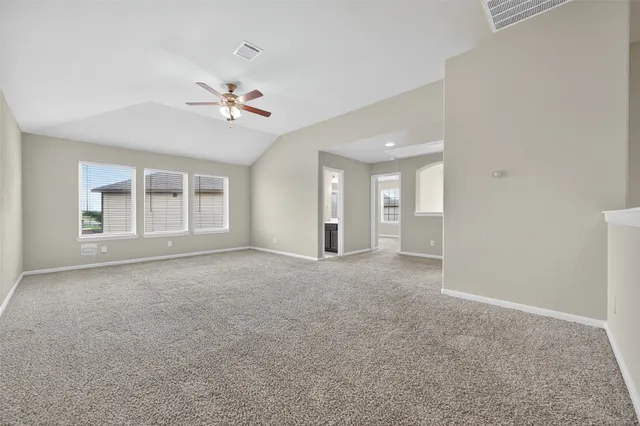 a view of a livingroom with a ceiling fan and window