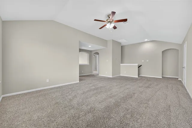 a view of a livingroom with a ceiling fan and window