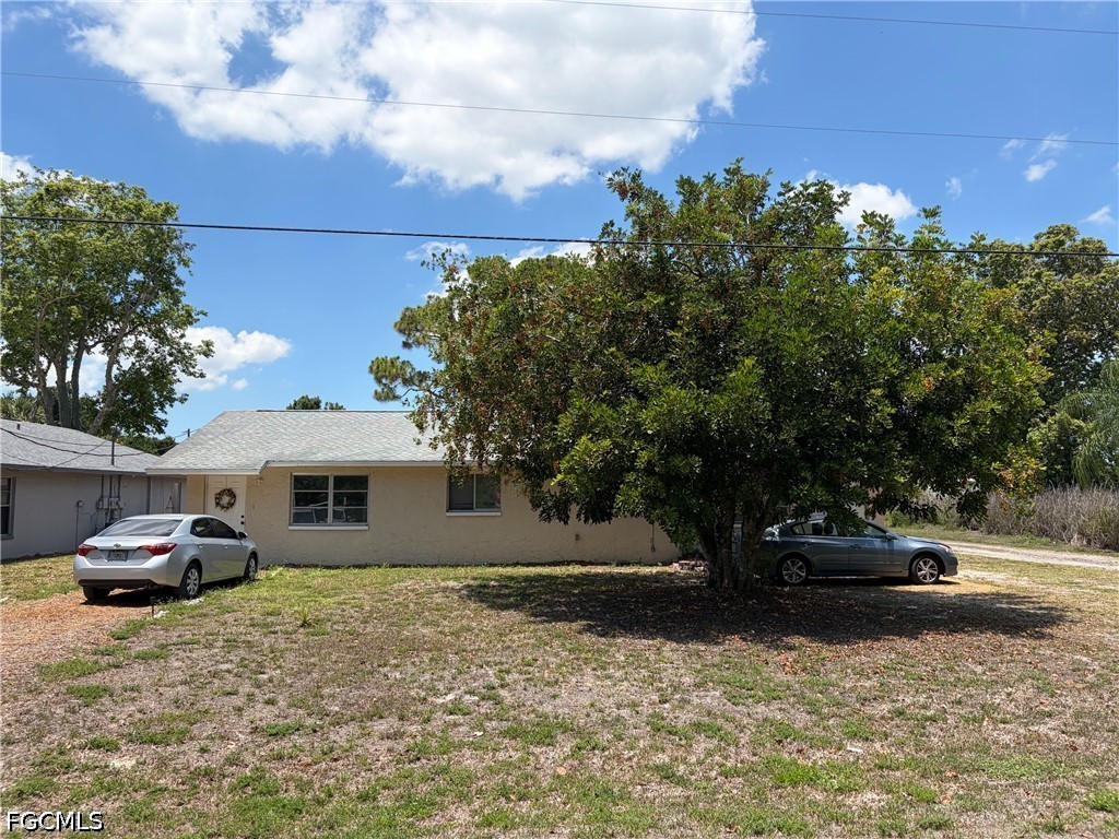 2175 Twin Brooks Road North Fort Myers, FL 33917 - Photo 1 of 27 a front view of a house with a yard
