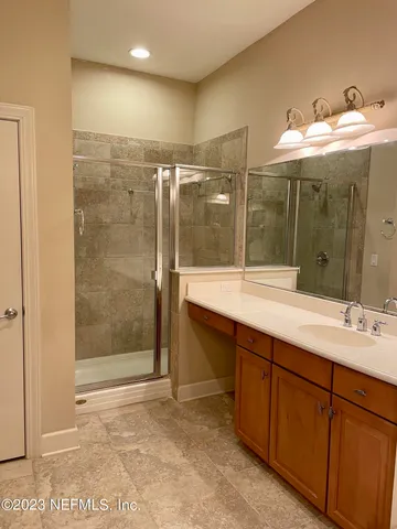 a bathroom with a tub sink and mirror