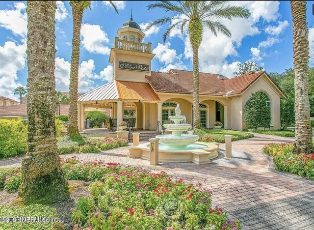 a view of a house with backyard and sitting area