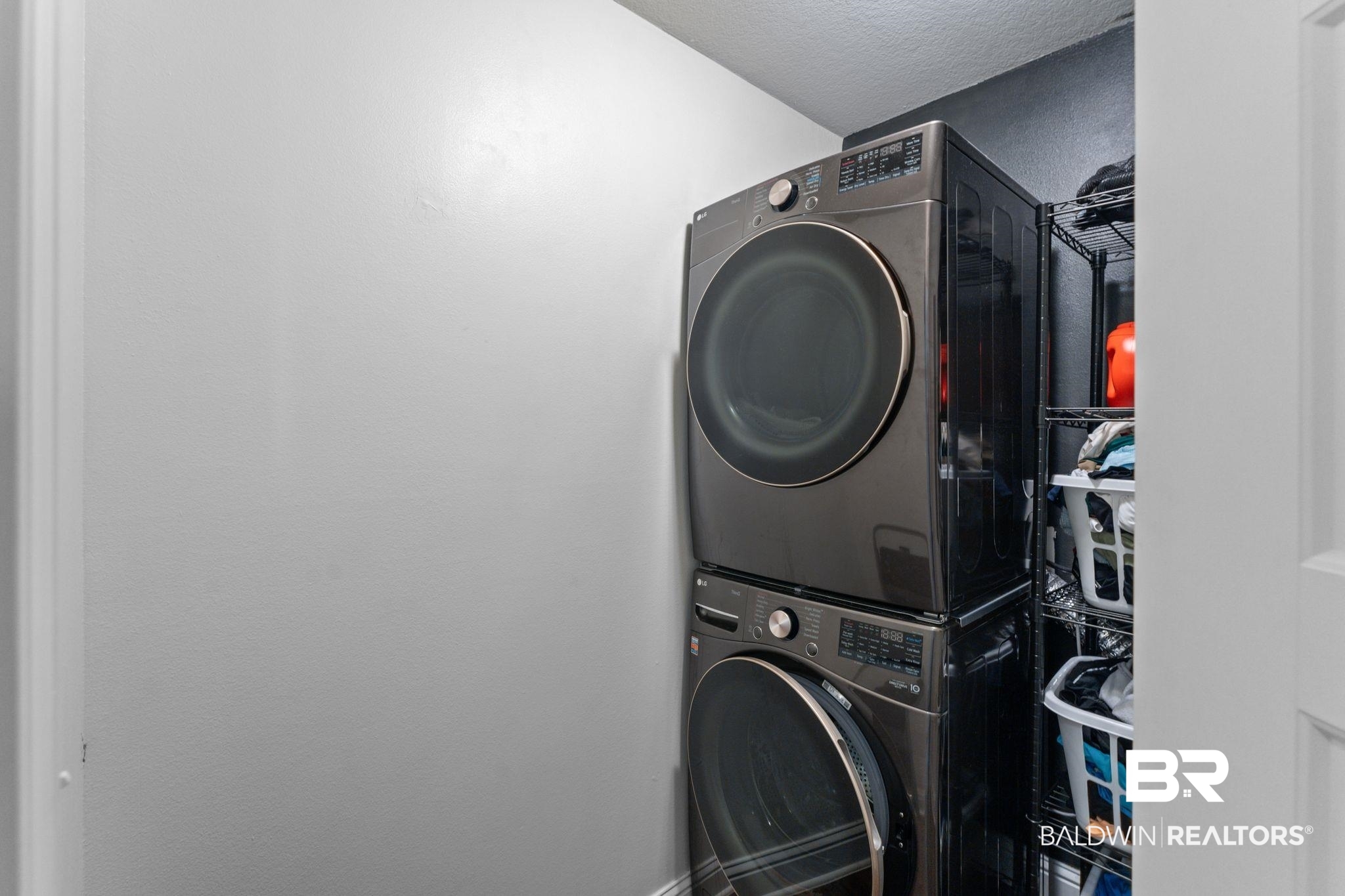 12711 Chickadee Lane Daphne, AL 36527 - Photo 27 of 39 Laundry room featuring stacked washer / dryer