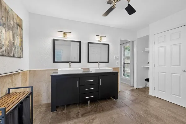 a spacious bathroom with a sink a mirror and a shower