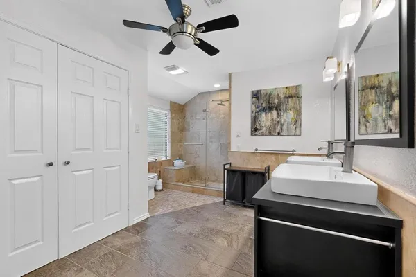 a spacious bathroom with a sink and a mirror