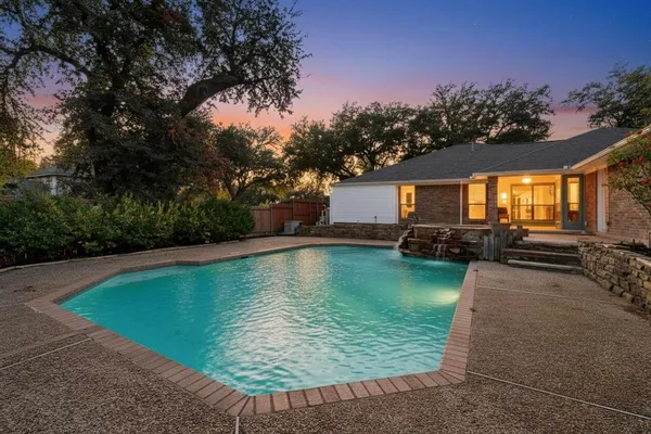 a view of a swimming pool with a yard