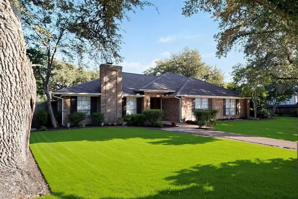 a front view of a house with a yard table and chairs