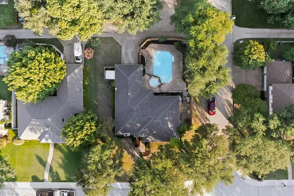 a aerial view of a house with a yard and garden