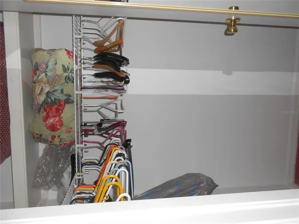 a view of a hallway to a livingroom with furniture