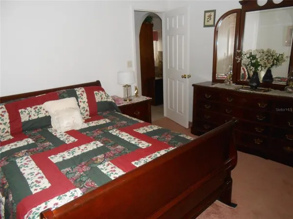 a bedroom with a bed and a dresser