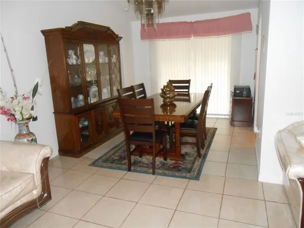 a kitchen with granite countertop a stove a sink a refrigerator and cabinets