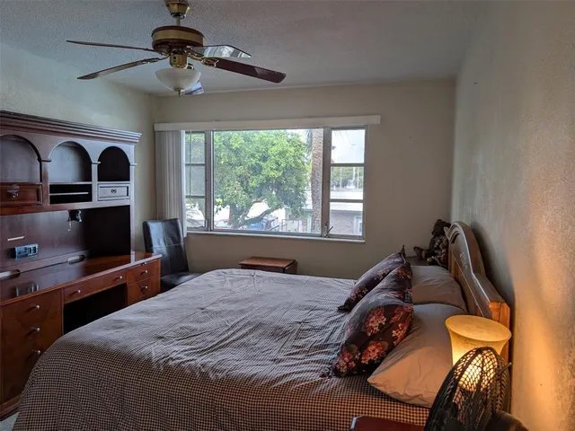 a bedroom with bed and a window