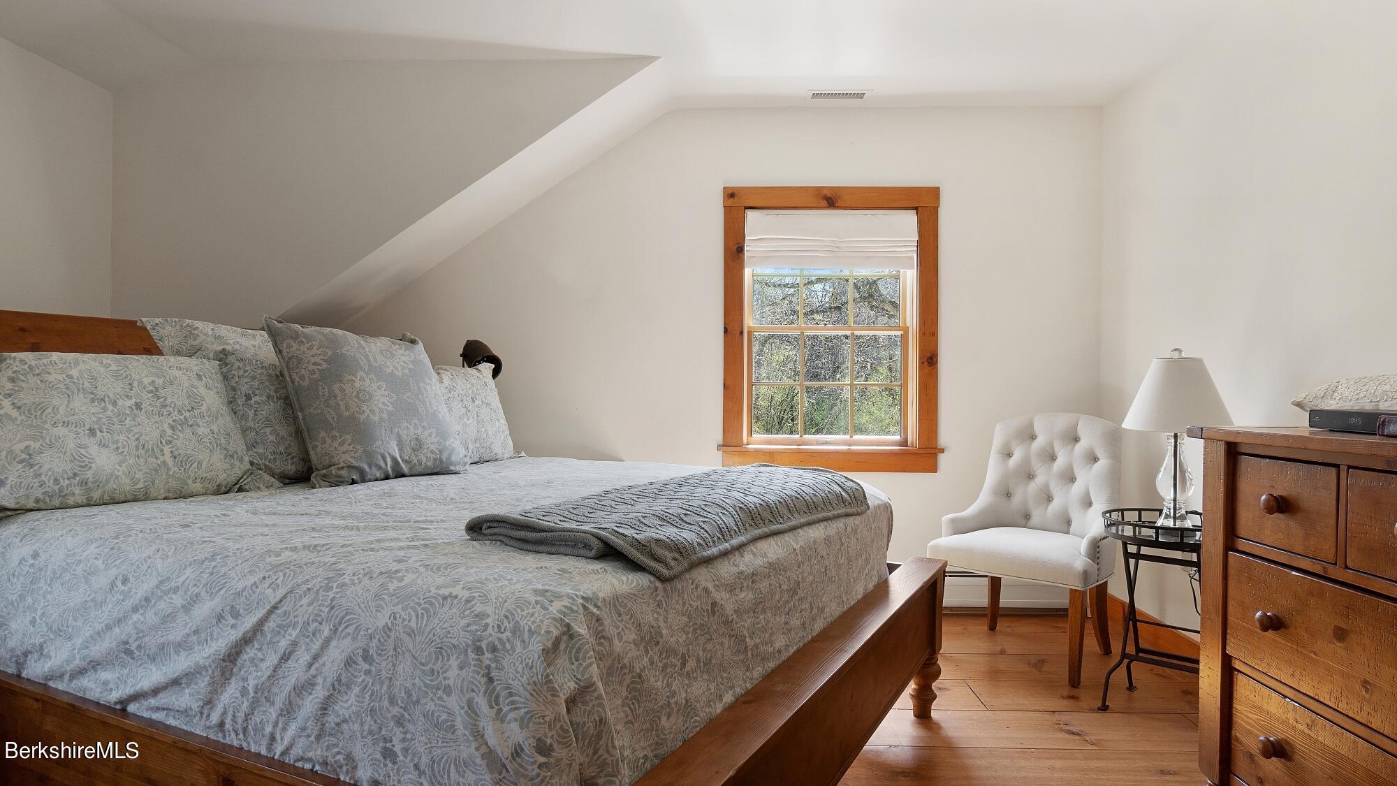 2 Hill Road Stockbridge, MA 01266 - Photo 14 of 24 a bedroom with a bed and wooden floor