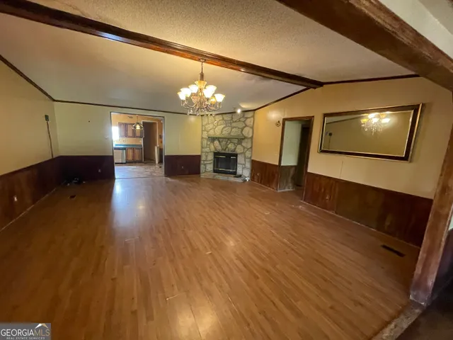 a large kitchen with granite countertop a stove a sink a refrigerator and dishwasher