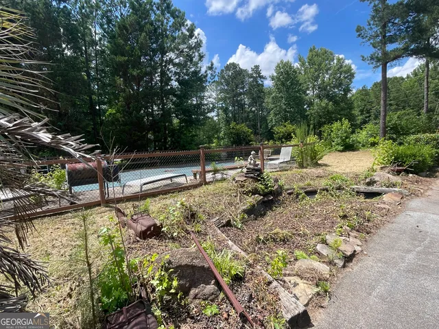 a view of a pool with a yard