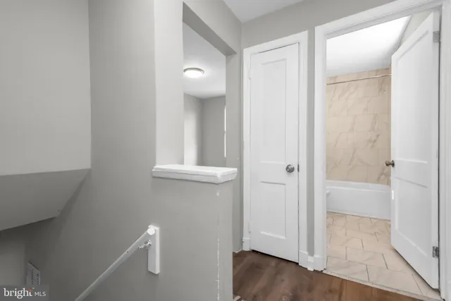 a view of a hallway with wooden floor