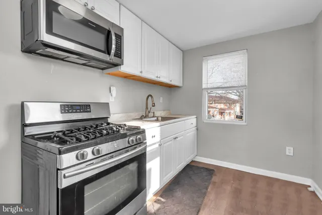 a kitchen with a sink cabinets and window