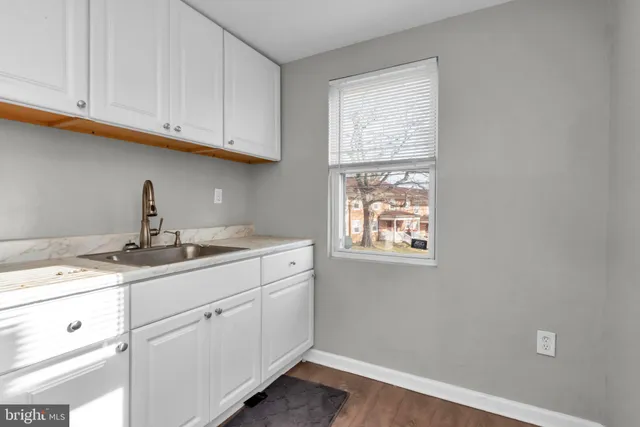 a kitchen with stainless steel appliances granite countertop a sink and a stove top oven