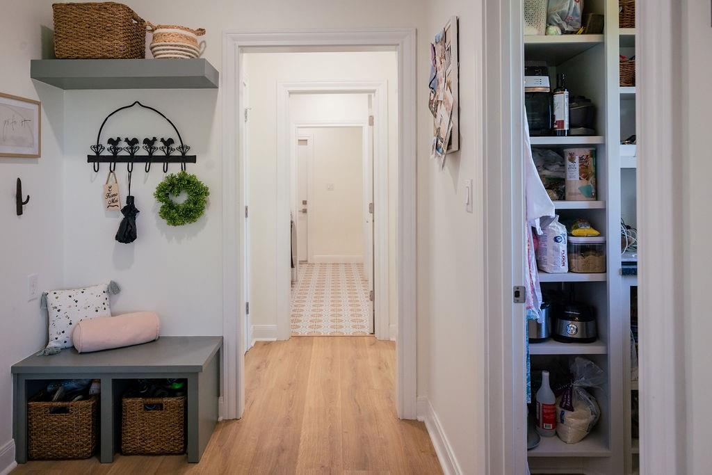 1132 Old Crawford Road Crawford, TX 76638 - Photo 19 of 39 a hallway with a book shelf and a wooden floor
