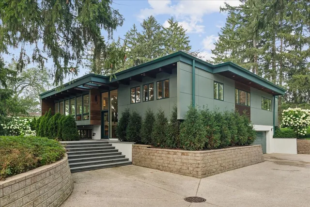 a front view of a house with a garden