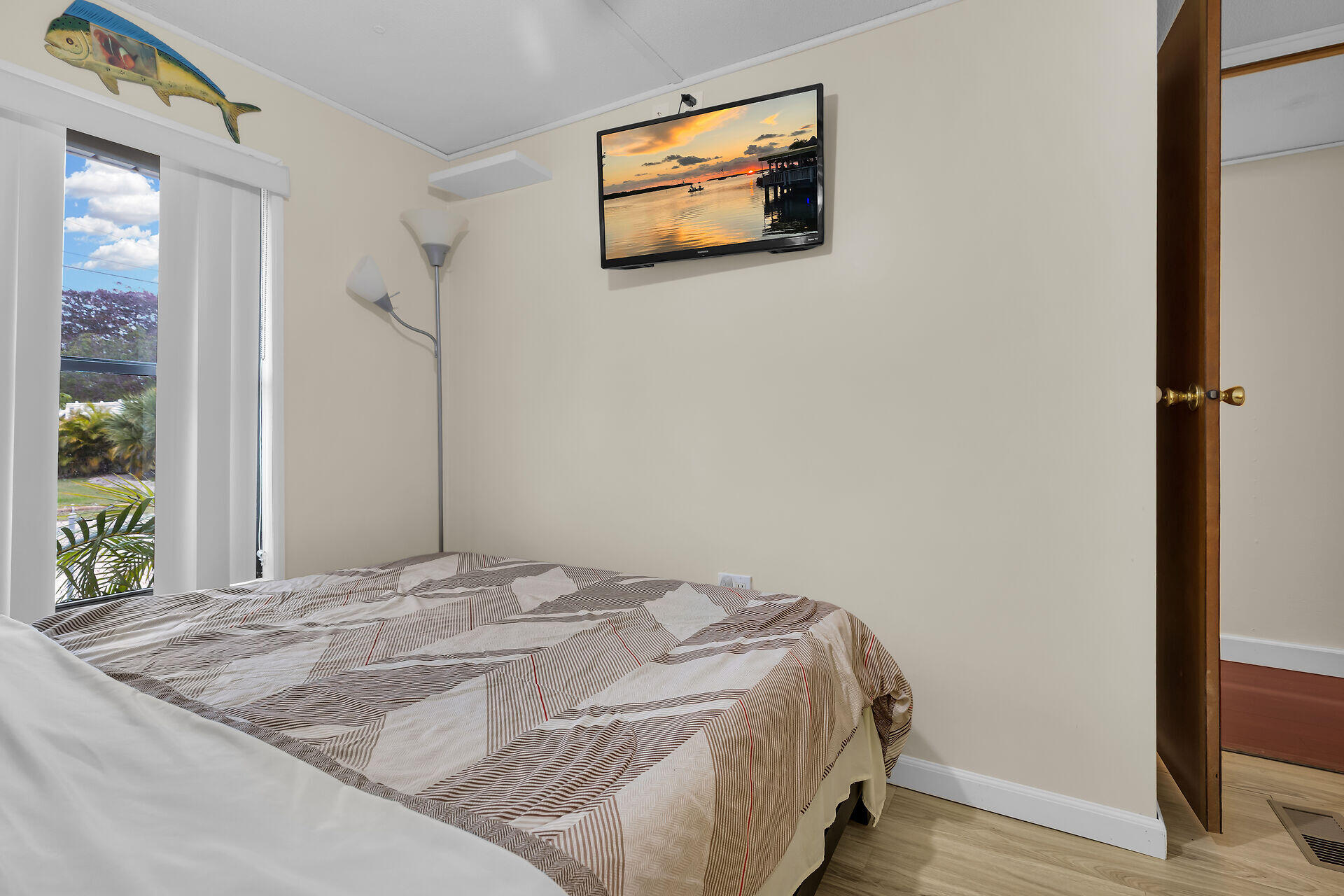 754 Michael Drive Key Largo, FL 33037 - Photo 14 of 23 a bedroom with a bed and a painting on the wall