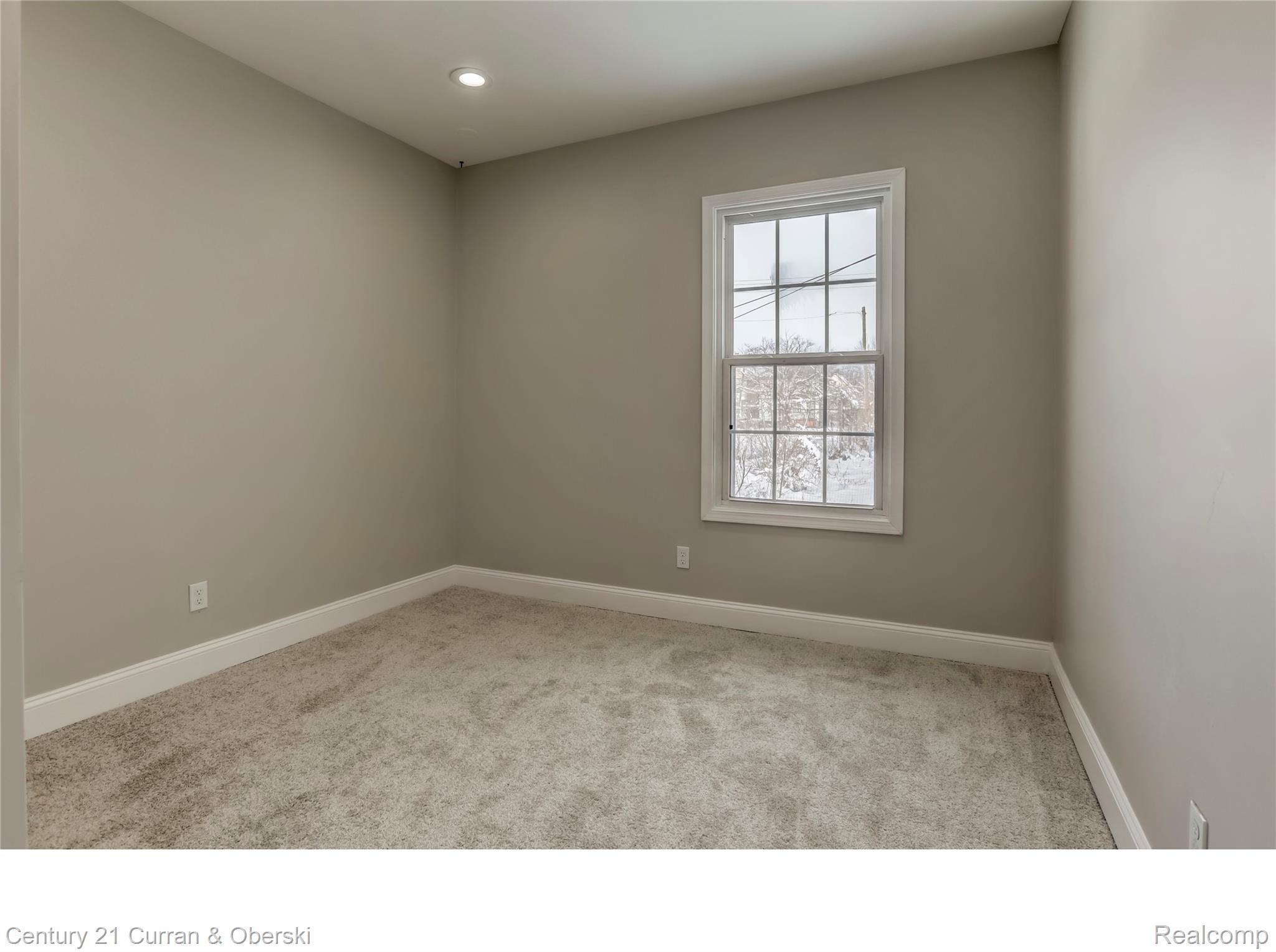 641 Josephine Street Detroit, MI 48202 - Photo 9 of 11 Interior space featuring light gray wall paint, white trim, recessed ceiling lighting, and neutral-toned carpeting