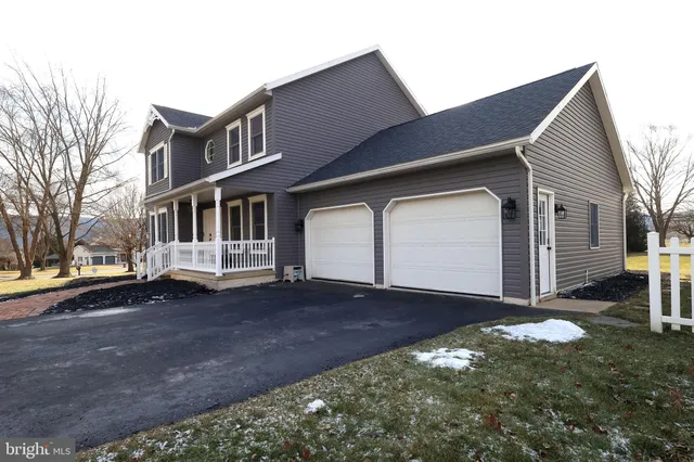a large white kitchen with a table and chairs