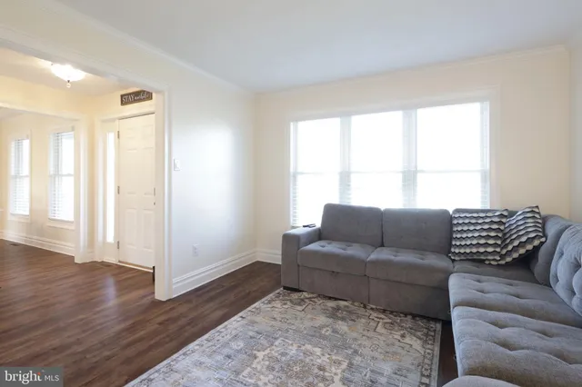 a living room with furniture and a ceiling fan