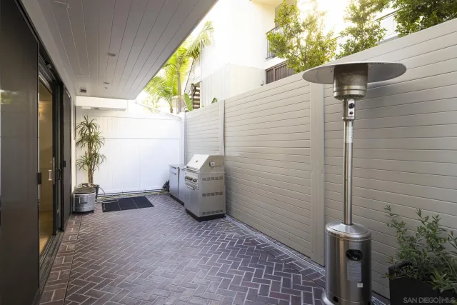 a view of a patio with table and chairs and potted plants