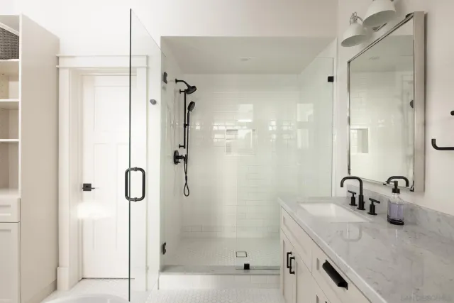 a bathroom with a shower sink and mirror