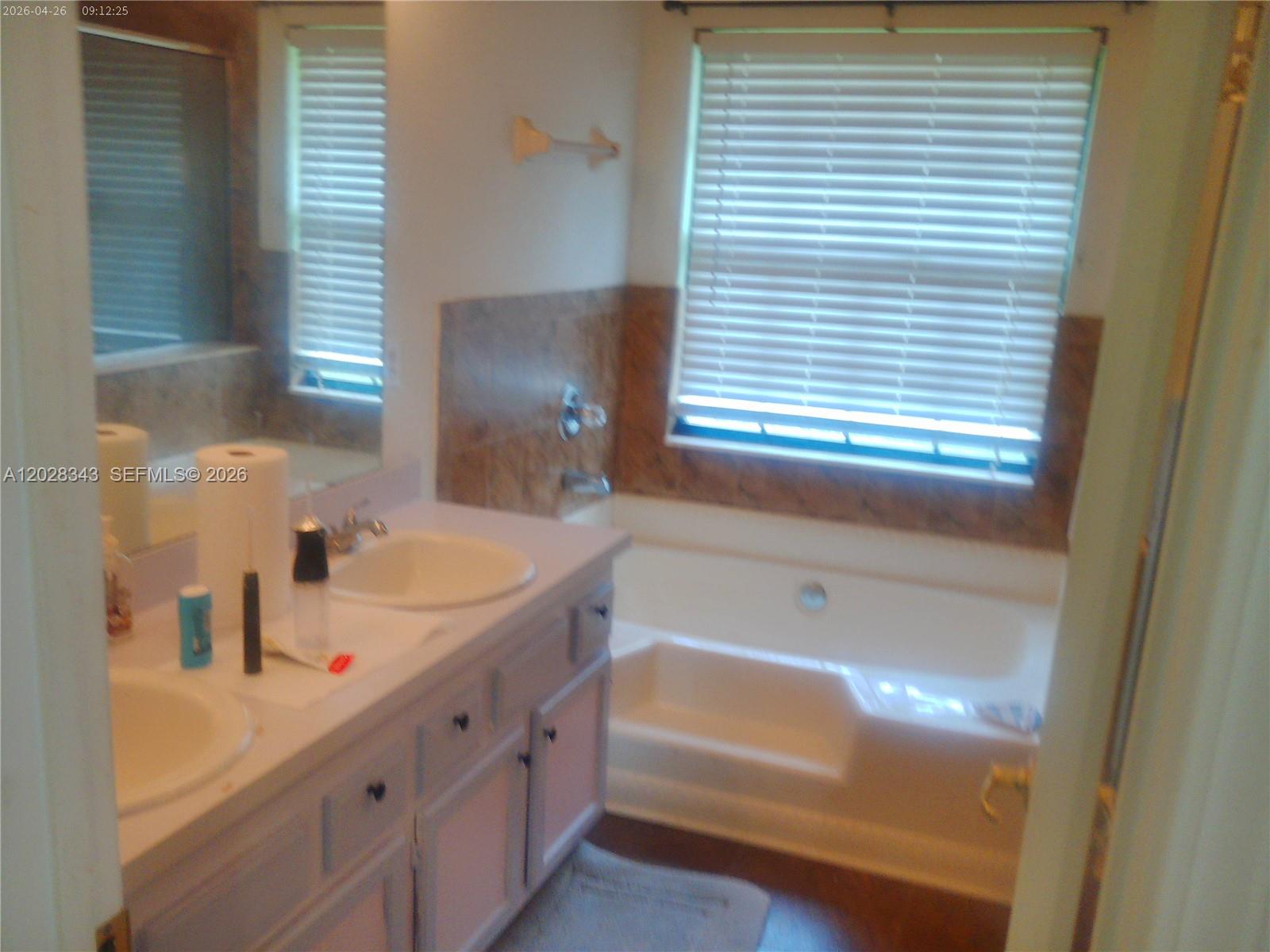 1641 Spring Oaks Lane Jacksonville, FL 32221 - Photo 31 of 44 a bathroom with a tub sink and a mirror