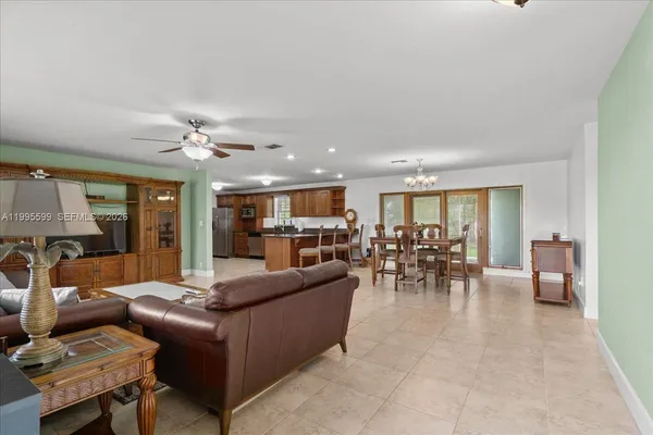 a kitchen with granite countertop a refrigerator and a sink