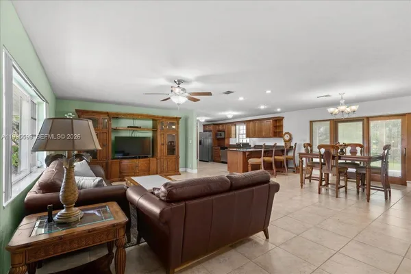 a large kitchen with stainless steel appliances kitchen island granite countertop a large counter top and a stove