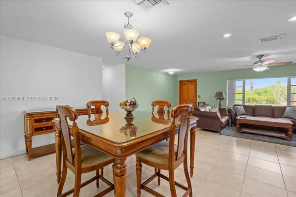 a bedroom with a bed and a ceiling fan