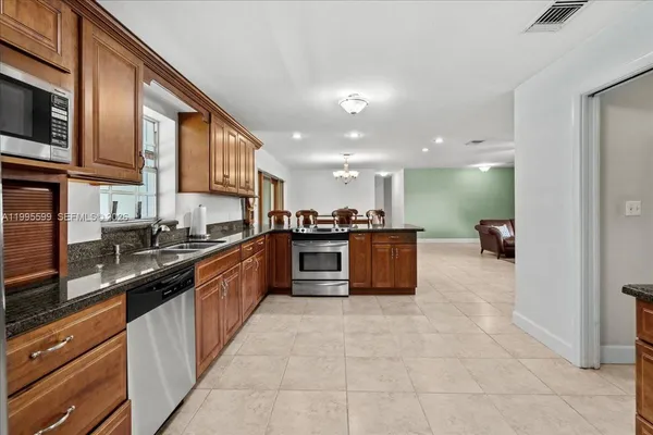 a utility room with cabinets washer and dryer