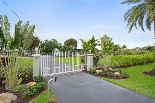 a view of a house with backyard sitting area and garden