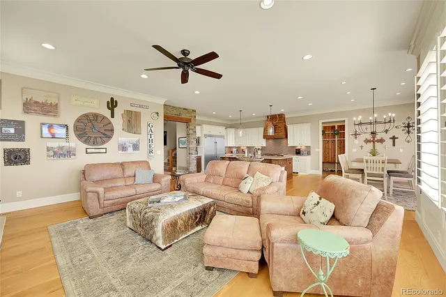 a living room with furniture and a view of kitchen
