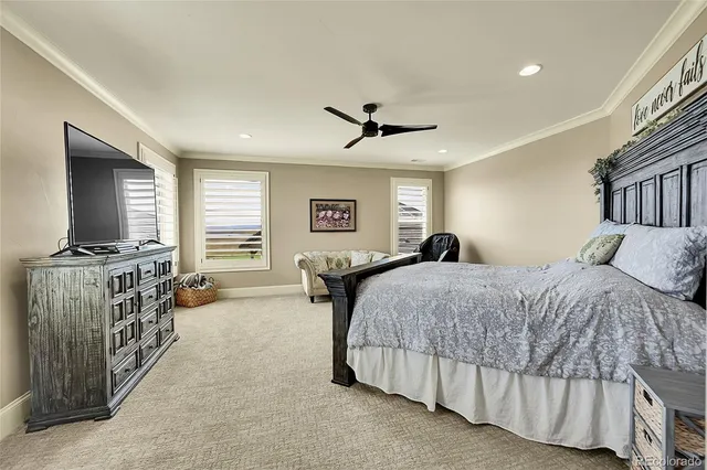 a spacious bedroom with a bed and a flat screen tv