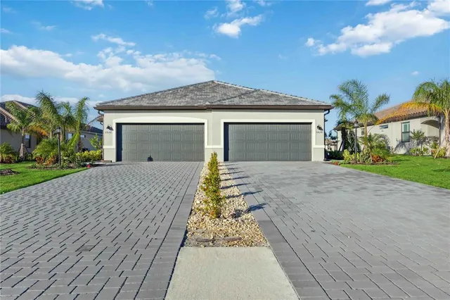 a front view of a house with a yard and garage