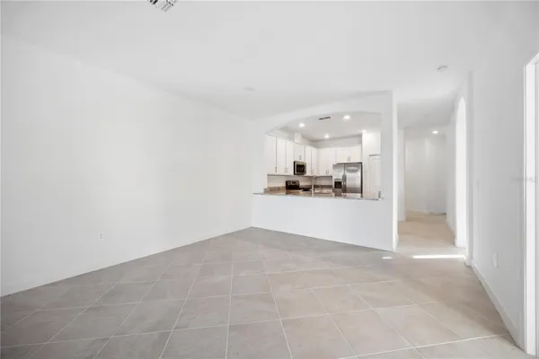 a view of a kitchen with kitchen island and wooden floor