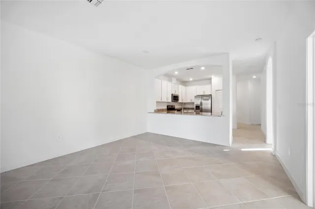 a view of a kitchen with kitchen island and wooden floor