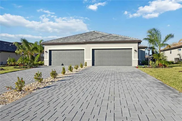 a front view of a house with a yard and garage