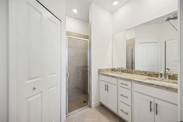 a bathroom with a granite countertop sink mirror and double