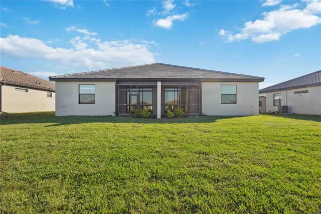 a view of a house with potted plants