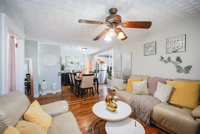 a living room with furniture kitchen view and a dining table